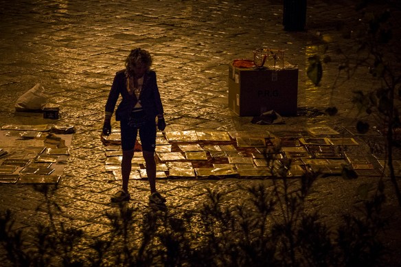 Street photo of a flea market in Palermo, at dawn, peddler